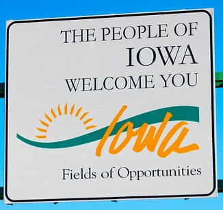 highway sign that reads, the people of Iowa welcome you. Fields of opportunities.